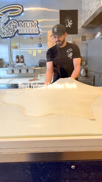 Stretching feteer dough by hand at Mum Feteer